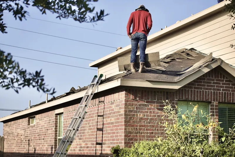 Professional roofer working on a residential roof in Youngs